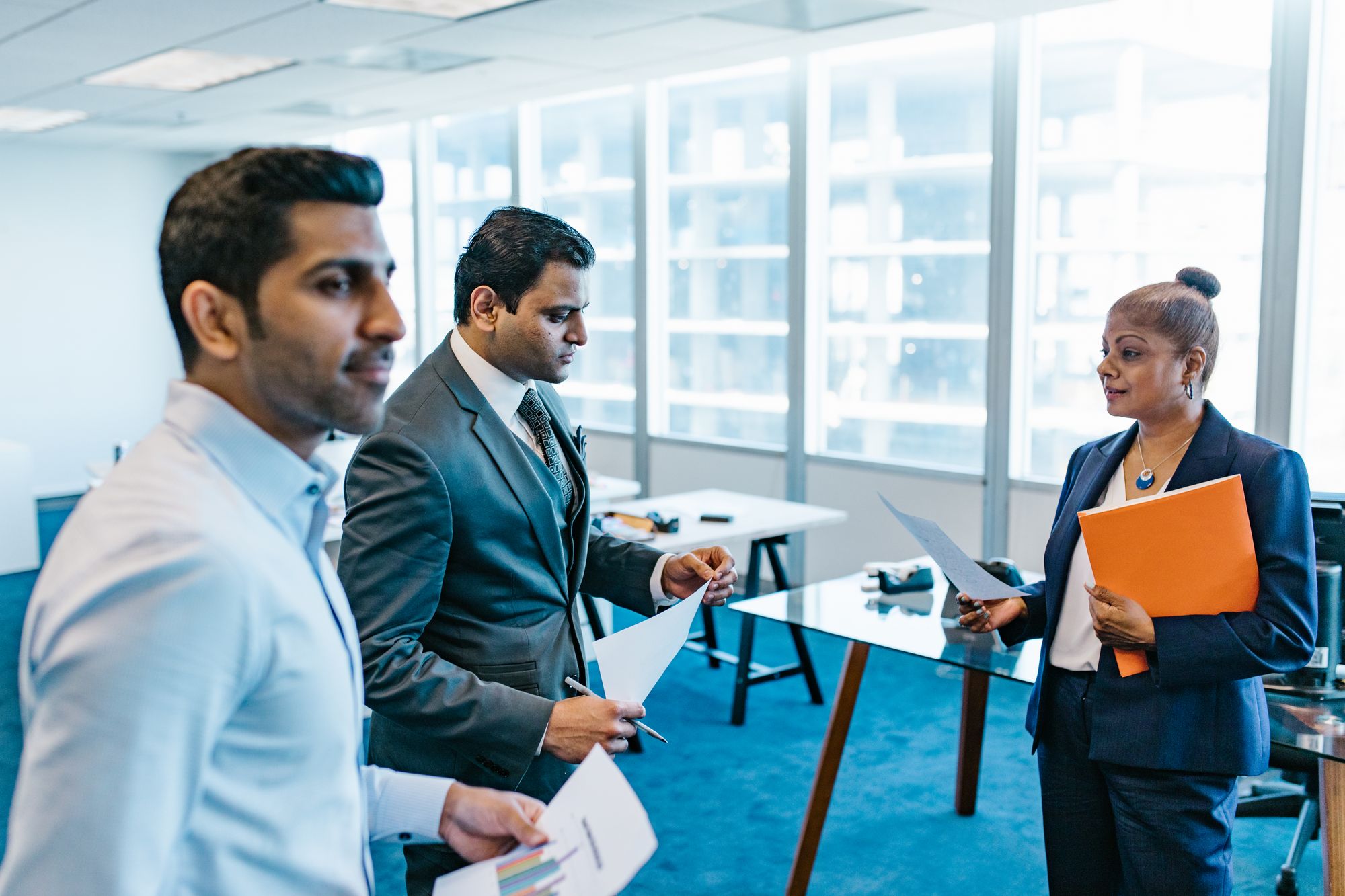 Recruitment consultants discussing candidate profiles in an office.